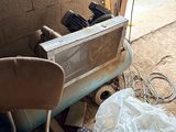 a dirty chair sitting in front of an old air conditioner