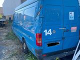 a blue van that is parked in front of a building