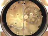 a close up of a clock with a bird on top of it