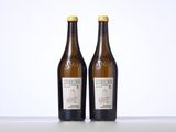 two bottles of wine sitting on top of a table next to each other