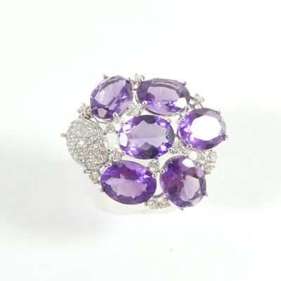 a close up of a ring with amethorate and diamonds