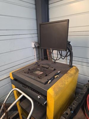 un ordinateur posé sur une machine dans un garage