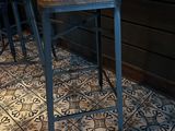 two stools sitting on a tiled floor in a room
