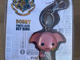 a pink pig keychain with a harry potter logo on it