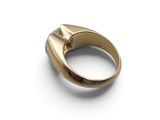 a close up of a gold ring on a white surface