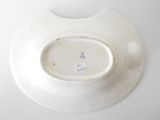 a white plate that has a small bowl on top of it