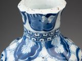a blue and white vase with a design on it