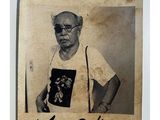 an old photo of a man with glasses and a t - shirt with a picture of a man on it