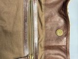 the inside of a brown bag with a zipper on it