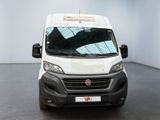 the front of a white van parked in a large room