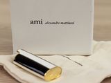a box of perfume sitting on a table next to a bag