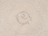 an image of a decorative glass plate with a monogram on it