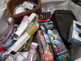 a basket full of books and other items on a bed