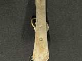 a small metal object with a chain attached to it
