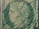 un timbre vert sur lequel figure la tête d'une femme