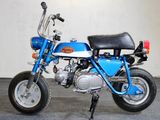 a small blue motorcycle parked in a garage