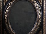 black and gold painted frame with a black background and a gold border