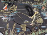 a black plate with a picture of a man and a woman fishing