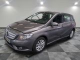 the mercedes b - class is parked on a checkered tile floor