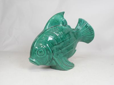 green ceramic fish figurine sitting on a white surface