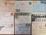 several old envelopes are sitting on a wooden table with writing on them