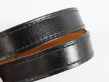 a close up of a hand holding a black leather belt