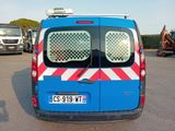a blue van with red and white stripes parked in a parking lot