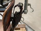 a old fashioned barber chair with a hair dryer on it