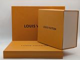 two louis vuitton boxes are open on a white surface