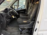 a white van with the door open and the driver ' s seat down