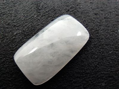 a close up of a white quartz stone on a black surface