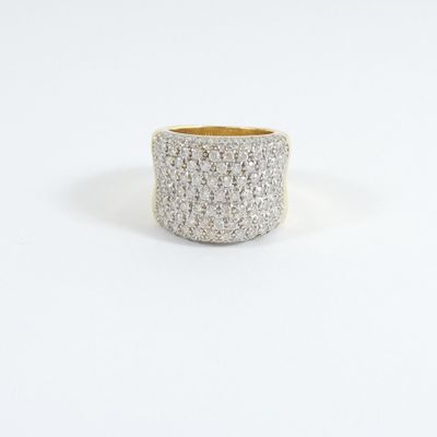 a close up of a white and gold ring on a white surface