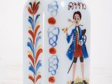 a glass bottle with a painting of a man on it