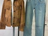 a mannequin with a jacket and jeans on a stand