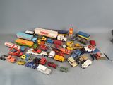 a lot of toy cars and trucks that are on the table