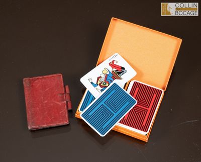 a box with playing cards and a wallet on a table