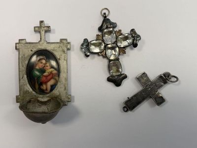three religious items are displayed on a white surface