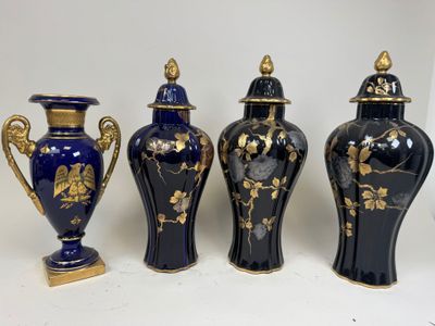 three blue vases with gold designs are lined up on a white surface