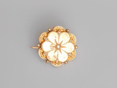 an 18k gold and diamond flower broochle