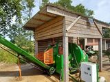 a green machine that is sitting in front of a building