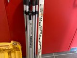 a pair of skis and ski poles next to a tool box