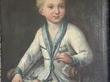 portrait of a young boy in a white dress and blue scarf