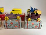 four toy cars that are sitting on top of boxes