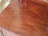 a wooden dresser with a mirror on top of it