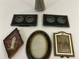 a vase, picture frame, picture, and picture on a table