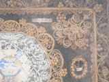 a picture of a decorative rug with a picture of a man on it