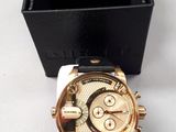 a watch sitting next to a box on a table