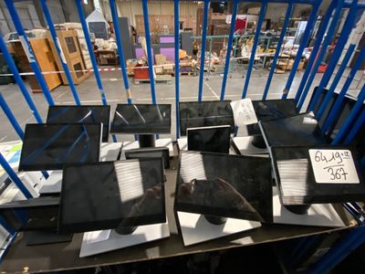 many laptops that are sitting on a table in the warehouse