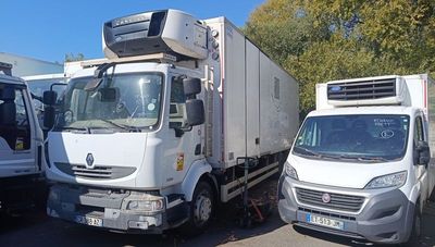 two trucks parked next to each other in a parking lot