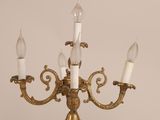 three candles that are on a gold colored chandelier